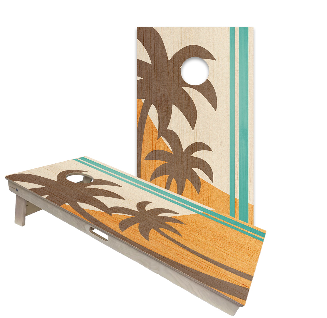 Beach cornhole boards with surf, sunset and dock designs in a coastal patio setting