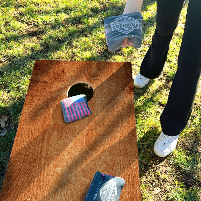 World Series of Cornhole Lightweight Cornhole Set - Dark Woodgrain Boards with Red and Royal Blue Bags