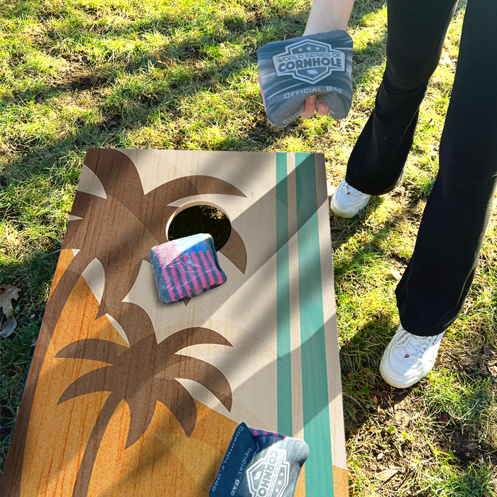 World Series of Cornhole Lightweight Cornhole Set - Palm Trees Boards with Red and Teal Bags