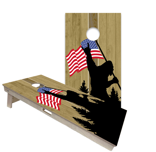 Bigfoot and Sasquatch professional cornhole boards in a forest cabin setting
