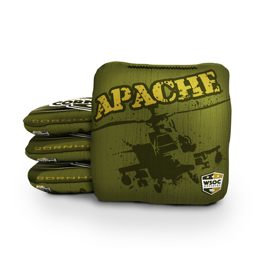 Military aircraft cornhole bags beside a regulation board in an aviation hangar